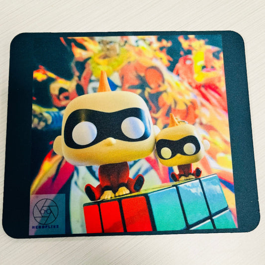 Two small figurines on a colorful mouse pad with a vibrant background